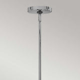 Close-up of the Congress 4 Light Clear Glass Chandelier in chrome against a grey background. The design highlights a round canopy and narrow rod, exuding modern elegance with its minimalist style and chrome finish.