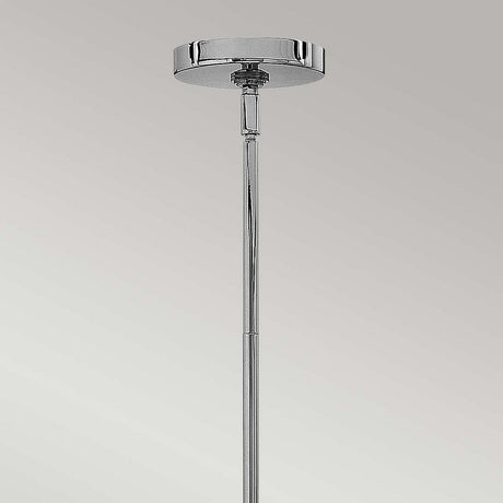 Close-up of the Congress 4 Light Clear Glass Chandelier in chrome against a grey background. The design highlights a round canopy and narrow rod, exuding modern elegance with its minimalist style and chrome finish.