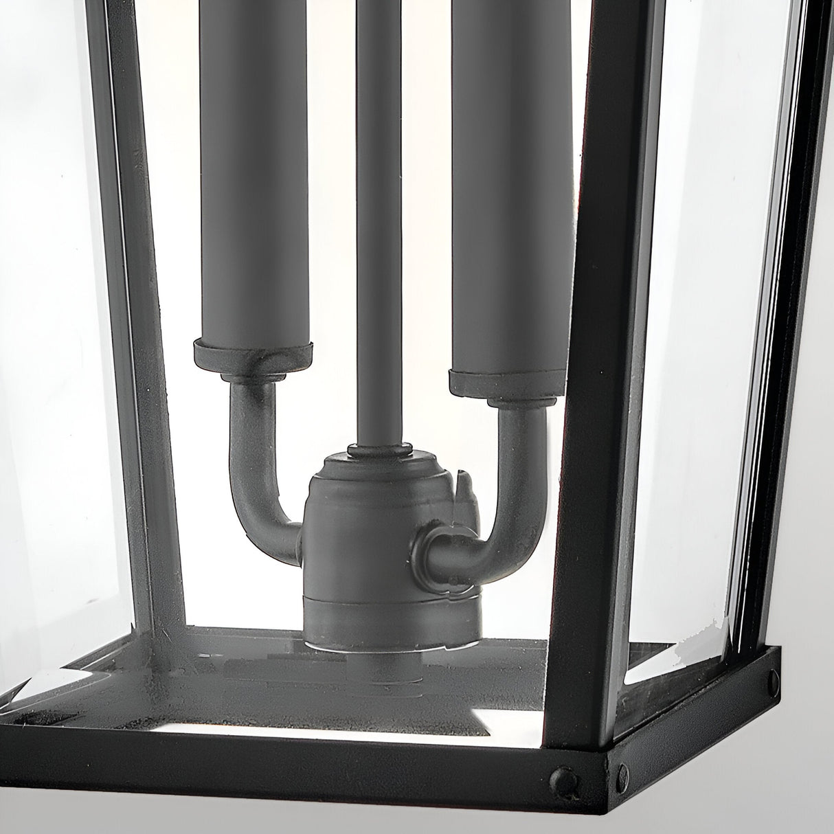 Close-up of the Dawson 1 Light Outdoor Large Wall Lantern in Black Oxide, featuring a black metal and glass design with visible electrical fittings and three cylindrical light sockets inside this classic exterior fixture.