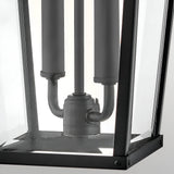 Close-up of the Dawson 1 Light Outdoor Large Wall Lantern in Black Oxide, featuring a black metal and glass design with visible electrical fittings and three cylindrical light sockets inside this classic exterior fixture.