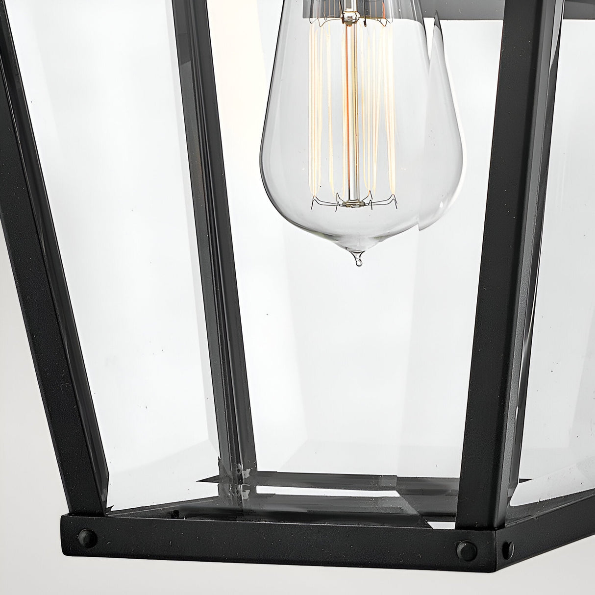 Close-up of the Dawson 1 Light Outdoor Medium Wall Lantern in Black Oxide, featuring a clear glass bulb that highlights its modern lines—ideal for adding stylish lighting to your patio.