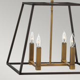 The Fulton 4 Light Pendant Chandelier - Bronze & Brass is a minimalist fixture with a modern geometric design. Its metal frame, finished in bronze and brass, gracefully suspends four candle-shaped bulbs from a central rod, making it an ideal match for any neutral gray background.