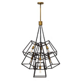 The Fulton 7 Light Chandelier - Bronze & Brass features a sleek geometric design made of interlocking black metal cubes surrounding exposed bulbs. It hangs gracefully from a bronze and brass rod, bringing a contemporary flair to any room.