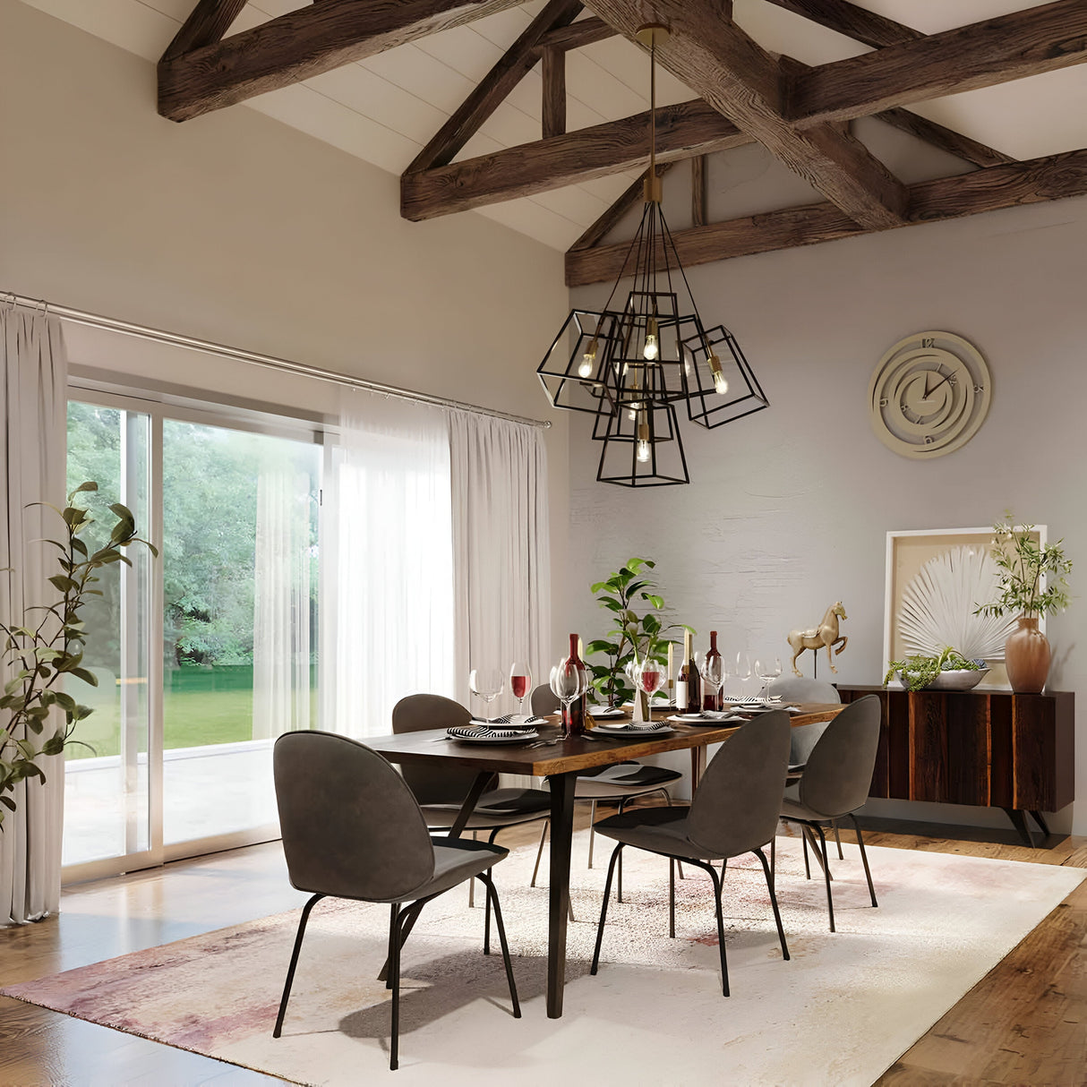 In a contemporary dining room, a wooden table set for six is surrounded by dark chairs. The table is elegantly adorned with wine glasses and red napkins. Above it, a Fulton 7 Light Chandelier in Bronze & Brass with a minimalist design hangs from the beamed ceiling. Large windows offer stunning views of the lush green outdoor space.
