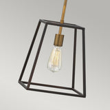 The Fulton 1 Light Pendant in Bronze & Brass showcases a geometric metal frame that encases an Edison bulb, exuding a vintage industrial style. Its minimalist design with a bronze frame and brass accents contrasts beautifully against a plain, light gray background.