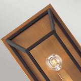 The Fulton 2 Light Wall Light, with its modern design, features a rectangular bronze frame and a wooden backplate. It showcases an exposed light bulb that softly illuminates your space. This piece effortlessly combines contemporary elegance with vintage industrial charm through its minimalist aesthetic.