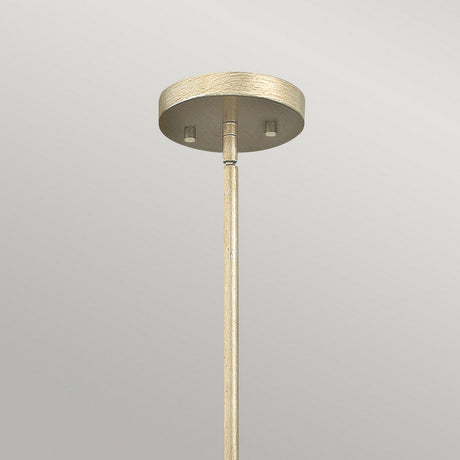The Gemma 1 Light Mini Pendant - Gold showcases a gold finish, complemented by a brass-colored ceiling fixture with a round base and an elongated vertical rod. Crystal prisms add an elegant touch to its minimalist design against a light gray background.