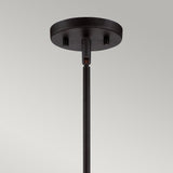 Close-up of the Gemma 3 Light Chandelier in vintage bronze, featuring a round base and single rod extending downwards for a contemporary style touch. The background is a plain off-white wall.