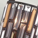 Detailed view of the Gemma-2 2 Light Wall Light - Vintage Bronze, showcasing vertical, rectangular glass panels in amber and clear hues set against a dark metal frame. This sophisticated design includes crystal prisms that partially conceal the glowing bulb within.