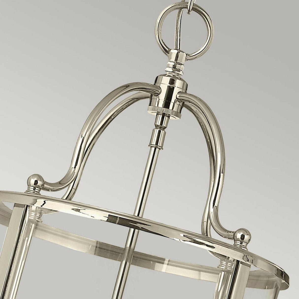 Close-up of the Gentry 4 Light Medium Pendant - Polished Nickel, showcasing its polished nickel finish. The design includes curved supports and a central rod, with a chain loop at the top set against a plain gray background.