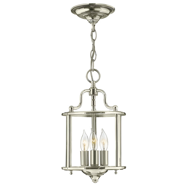 The Gentry 3 Light Small Pendant in polished nickel showcases a classic lantern design with three candle-shaped bulbs enclosed within clear bent glass, all suspended from a decorative chain.