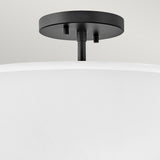 Close-up of the Graham 3 Light Duo-Mount Pendant/Semi-Flush in Black, showcasing a luminous faux parchment shade with a black welded frame, set against a neutral background.