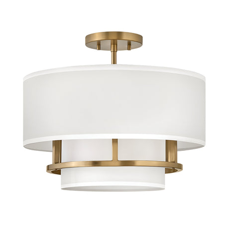 The Graham 3 Light Duo-Mount Pendant/Semi-Flush - Lacquered Brass is a modern ceiling fixture featuring a cylindrical white fabric shade complemented by lacquered brass accents and a brass ceiling mount. Its sophisticated design combines contemporary aesthetics with dual-mount capability, offering versatile installation options.