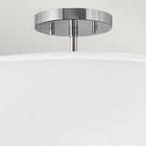A close-up of the Graham 3 Light Duo-Mount Pendant/Semi-Flush featuring a polished nickel finish and a white shade. This fixture boasts a sleek, contemporary design, ideal for both home and office interiors.