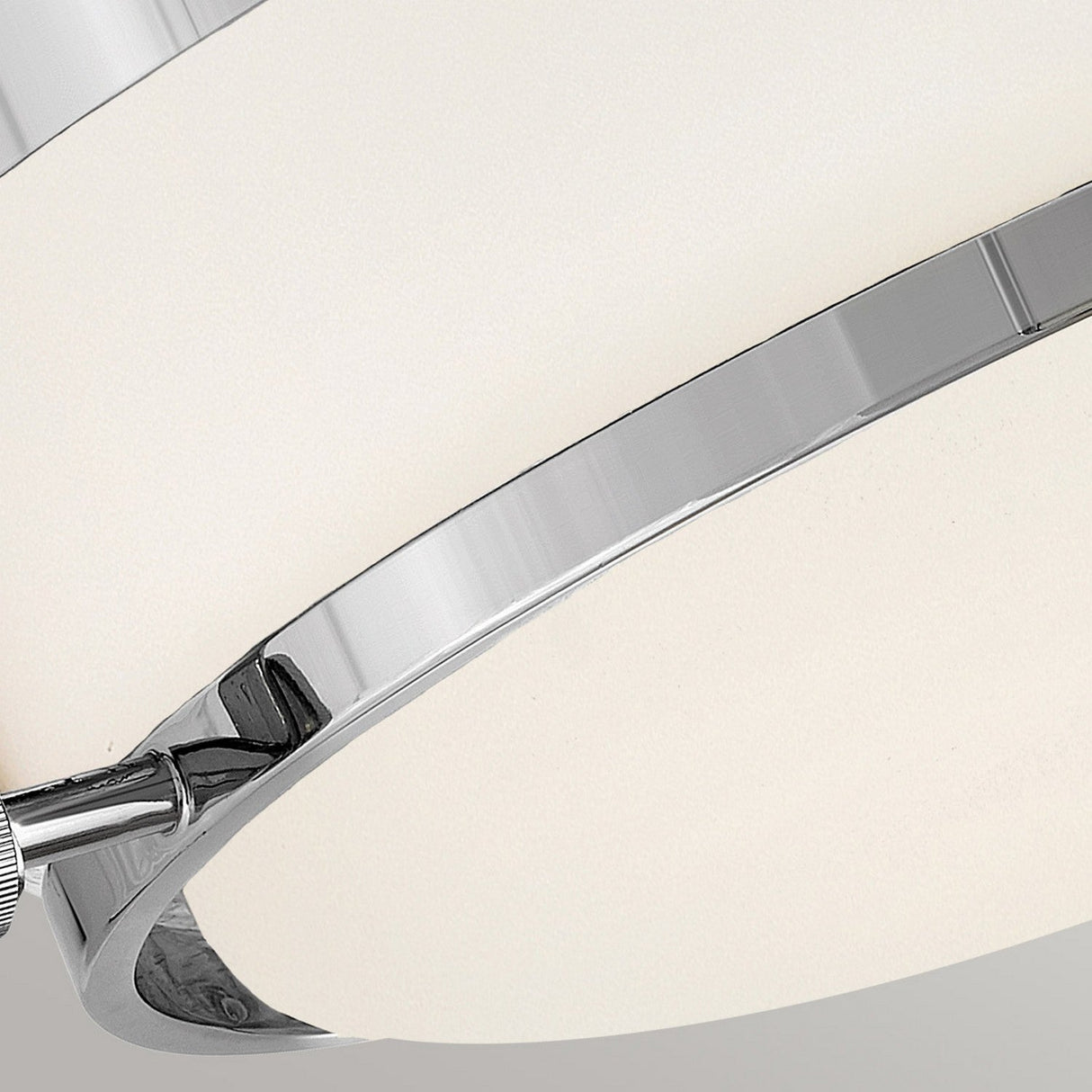 Close-up of the Harper 3 Light Flush in polished chrome, featuring an opal etched glass cover for a minimalist aesthetic. The elegant fixture is positioned at an angle against a simple backdrop.