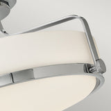 A close-up of the Harper 3 Light Medium Semi Flush showcases its modern design, featuring a polished chrome metal frame supporting an oval-shaped opal etched glass shade. The minimalist aesthetic with clean lines is highlighted against a plain gray background.