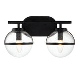 The Hollis 2 Light Wall Light in black features two transparent glass globe shades that expose the bulbs. The speckled glass texture enhances its modern design with Art Deco elements, offering a sleek and stylish appearance.