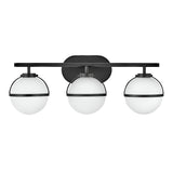 The Hollis 3 Light Wall Light - Black With Opal Glass showcases a contemporary design with three opal glass globes, each enclosed in a sleek black metal frame, evenly distributed along a horizontal black bar, seamlessly merging modern elegance with vintage charm.