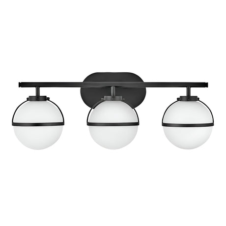 The Hollis 3 Light Wall Light - Black With Opal Glass showcases a contemporary design with three opal glass globes, each enclosed in a sleek black metal frame, evenly distributed along a horizontal black bar, seamlessly merging modern elegance with vintage charm.