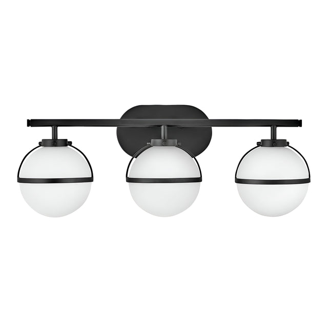 The Hollis 3 Light Wall Light - Black With Opal Glass showcases a contemporary design with three opal glass globes, each enclosed in a sleek black metal frame, evenly distributed along a horizontal black bar, seamlessly merging modern elegance with vintage charm.