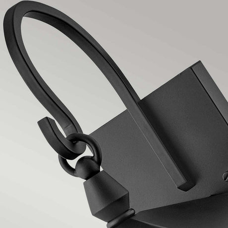Close-up of the Huntersfield Outdoor 2 Light Medium Wall Lantern in black, featuring a modern curved design with interconnected loops, crafted from durable aluminum, set against a light gray background.
