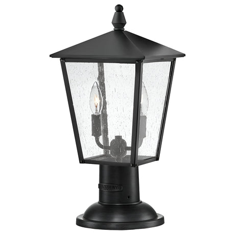The Huntersfield Outdoor 2 Light Medium Pedestal Lantern in black showcases a classic design with a tapered square shape and clear glass panels. It is IP44 rated, featuring two candle-style bulbs inside, and the textured glass has a raindrop-like pattern. Its medium pedestal base provides both sturdiness and elegance.