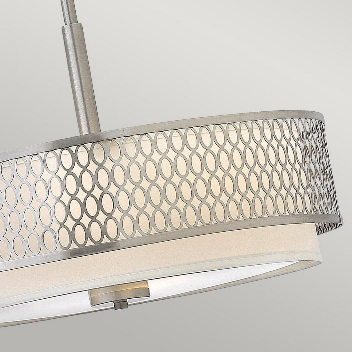 The Jules 3 Light Pendant / Semi-Flush - Brushed Nickel is a modern ceiling fixture featuring a circular design with a brushed nickel finish and geometric pattern. It exudes contemporary elegance and is suspended by a central rod against a neutral grey backdrop.