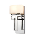 The Lanza 1 Light Wall Light in polished chrome boasts a rectangular metal base and an opaque white glass shade, highlighting its geometric design and contemporary craftsmanship for a sleek, modern appearance.