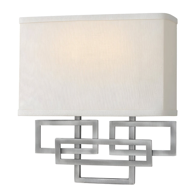 The Lanza 2 Light Wall Light - Antique Nickel seamlessly combines modern and traditional elements, featuring a rectangular white fabric shade and an antique nickel geometric metal frame with overlapping shapes that offer both a contemporary and timeless appeal.