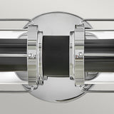 The Masthead 2 Light Wall Light in polished chrome and black beautifully highlights nautical charm with its cylindrical glass casing and polished chrome finishes. It features a symmetrical design and sleek lines set against a neutral backdrop, adding an air of elegance and style.
