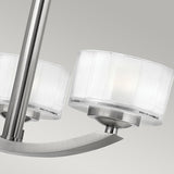 Close-up of the Meridian 3 Light Semi Flush in a brushed nickel finish, featuring frosted cylindrical glass shades, set against a neutral background. This energy-efficient design is minimalist and ideal for modern interiors.