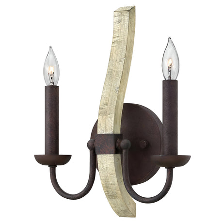 The Middlefield 2 Light Wall Light - Iron Rust features two candle-shaped bulbs on gracefully curved metal arms and is mounted on a wooden base. Its iron rust finish complements the dark brown metal and light-colored wood, combining vintage charm with energy-efficient bulbs for modern flair.