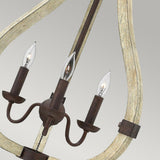 Introducing the Middlefield 3 Light Chandelier in Iron Rust, this piece showcases a rustic chic design with a wooden frame and metal candle-like bulb holders. Its teardrop-shaped bulbs enhance the elegant curved lines, all beautifully highlighted against a light gray background.