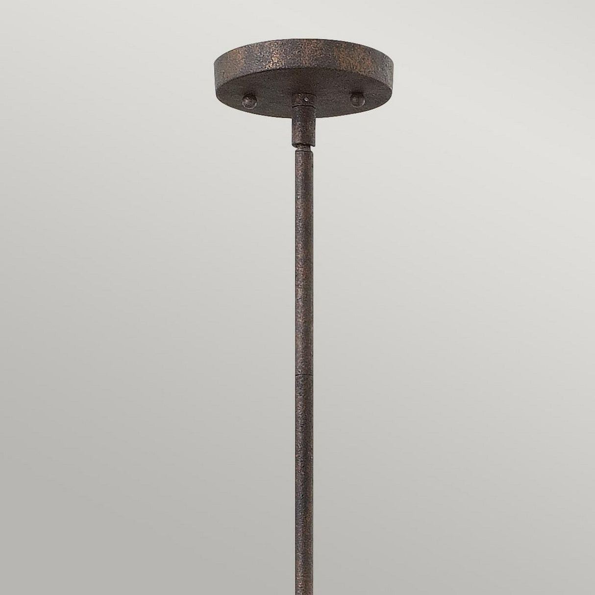 The Middlefield 1 Light Mini Pendant in Iron Rust, showcased against a light gray background, captures the essence of vintage charm lighting. Its textured finish and round ceiling mount enhance its timeless appeal.