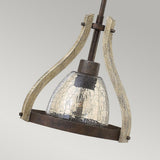 The Middlefield 1 Light Mini Pendant in Iron Rust exudes vintage charm with its cracked glass shade and distressed wood metal frame. Hanging gracefully from a sleek rod, it seamlessly complements any neutral background.