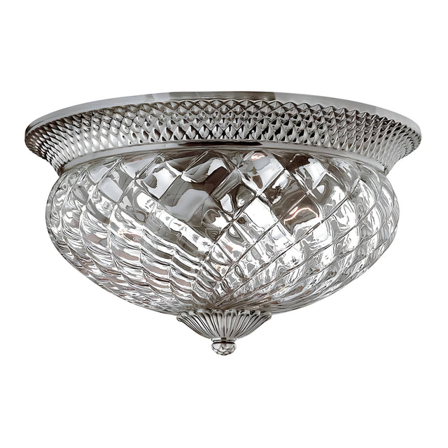 This decorative flush mount ceiling light, officially known as the Plantation 3 Light Large Flush - Polished Antique Nickel, features a diamond-patterned, pineapple-shaped clear optic glass shade and a polished antique nickel rim. Its classic design enhances any space with a vintage touch and elegant appeal.