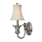 The Plantation 1 Light Wall Light in Polished Antique Nickel showcases a floral design with a fabric lampshade. Its textured circular backplate and gracefully curved arm are enhanced by a pineapple-shaped accent beneath the shade, bringing elegance to any room.