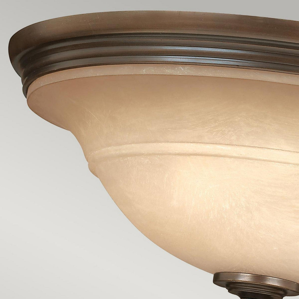 A close-up of the Plymouth 3 Wall Light - Bronze, showcasing its elegant ceiling light fixture with an Old Bronze finish and a frosted glass shade. The design, adorned with vintage-inspired candle sleeves, features a subtle classic shape similar to a shallow bowl against a plain white background.