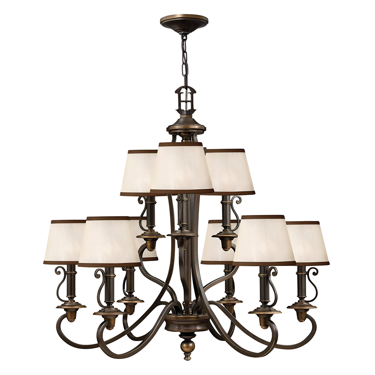 The Plymouth 9 Light Chandelier in Bronze is a large, elegant piece featuring an old bronze finish with nine cream-colored square lampshades arranged in two tiers. It boasts vintage-inspired candle sleeves, ornate curved arms, and decorative detailing, making it the perfect addition to classic or traditional interiors.