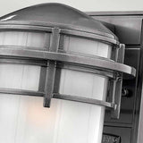 Close-up of the Reef Outdoor Small 1 Light Lantern - Grey, showcasing its dome-shaped top and frosted glass shade. This IP44-rated fixture is made from cast aluminum and features metallic crossbars for added detail.