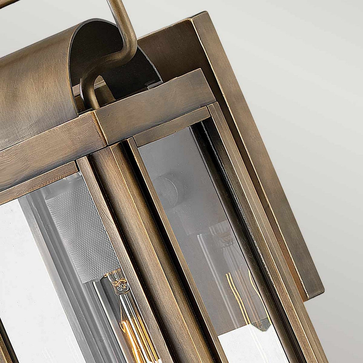Close-up view of the Sag Harbor Outdoor 1 Light Small Wall Lantern in a painted burnished bronze finish, featuring glass panels with a visible bulb inside. This IP44 rated design showcases clean lines and a classic aesthetic, perfect for exterior lighting.