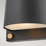 A detailed look at the Scout Outdoor 1 Light Small Wall Light in black reveals its minimalist design. The partially visible light emits a soft glow, and the fixture's small brass accent adds elegance. This weather-resistant wall sconce is ideal for outdoor use.