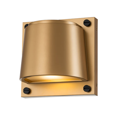 A modern wall sconce in a gold tone, similar to the Scout Outdoor 1 Light Small Wall Light - Painted Heritage Brass, features a conical shade and is mounted on a square base with black fasteners. Its painted heritage brass finish provides a soft warm light, ideal for outdoor illumination.