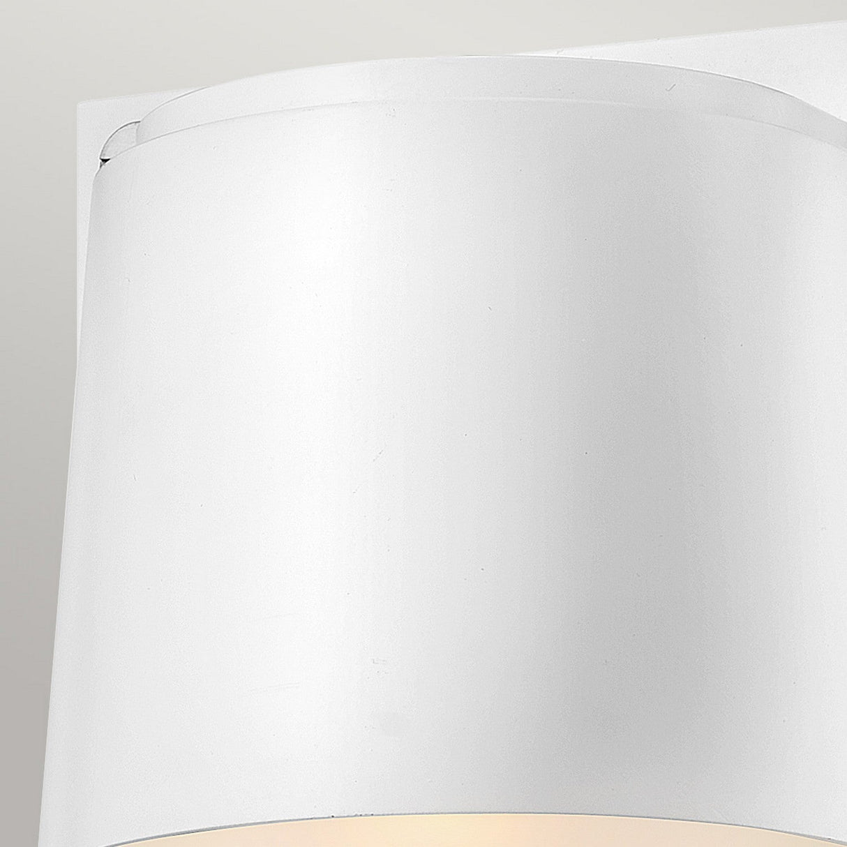Close-up of the Scout Outdoor 1 Light Small Wall Light in a sleek curved design against a light gray background. This modern sconce, featuring an elegant satin white finish, emits a gentle warm light from below.