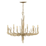 A Spyre 6 Light Chandelier in the Champagne Gold finish hangs from the ceiling with a rustic antler design. It features six light bulbs arranged in a circular pattern, emitting a warm glow. The chandelier has a natural, wood-like appearance accented with elegant Champagne Gold touches.