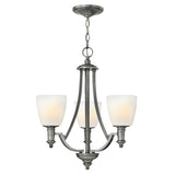 The Truman 3 Light Chandelier - Antique Nickel features a timeless design with gracefully curved arms extending from a central column. It is adorned with etched opal glass shades and elegantly hangs from a chain, perfectly showcasing its antique nickel finish.