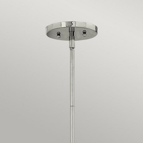 Introducing the Zelda 1 Light Mini Pendant in Polished Nickel, a minimalist chrome ceiling mount featuring a sleek cylindrical rod that embodies mid-century elegance. It extends gracefully downward, beautifully contrasting against a plain gray background.
