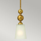 The Zelda 1 Light Mini Pendant in a vintage brass finish features a gold metal rod and two spherical accents. Its mid-century design includes a frosted white, cone-shaped glass shade that casts a soft, diffuse glow against the plain gray background.