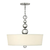The Zelda 3 Light Pendant - Polished Nickel exudes mid-century charm with its polished nickel finish. This modern pendant light features a chrome chain and three metallic spheres, complemented by a large, cylindrical white fabric shade for a sleek and contemporary design.
