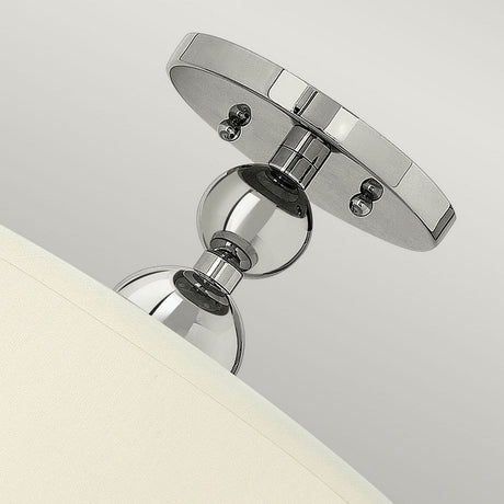 A close-up of the Zelda 3 Light Semi Flush - Polished Nickel features a contemporary semi-flush design with two spherical elements connecting a round mounting base to a smoothly curved white shade. The fixture is turned off and set against a neutral background.